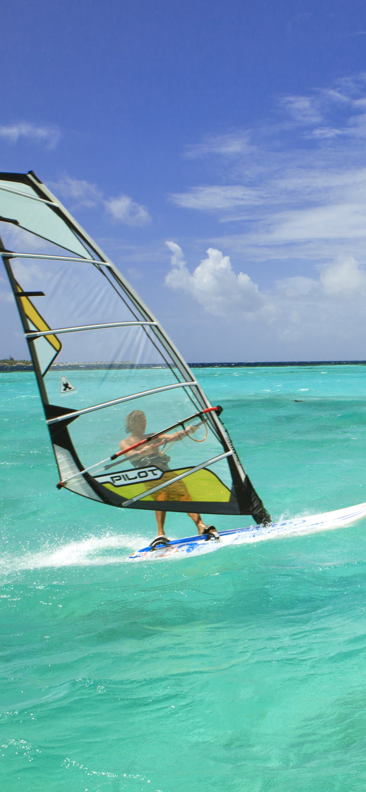 Velero Azul y Amarillo en el Mar Bajo un Cielo Azul Durante el Día. Wallpaper in 1242x2688 Resolution