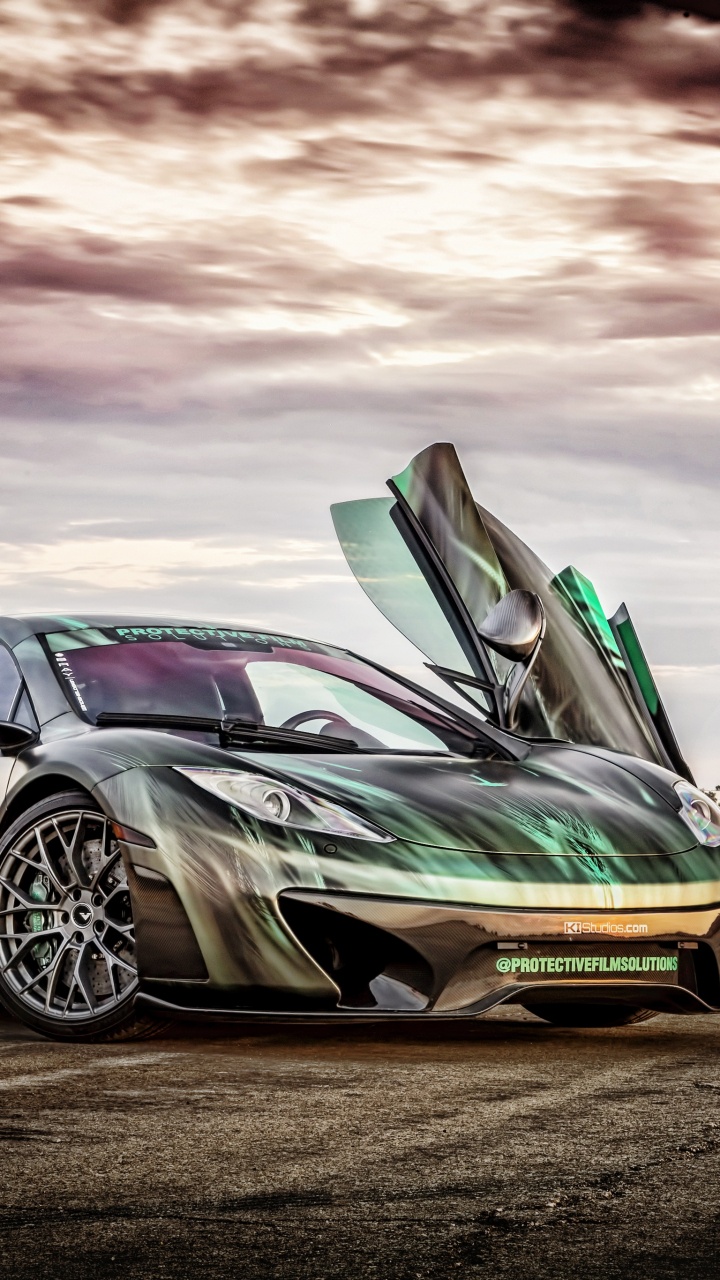 Green Porsche 911 on Brown Field Under Cloudy Sky. Wallpaper in 720x1280 Resolution