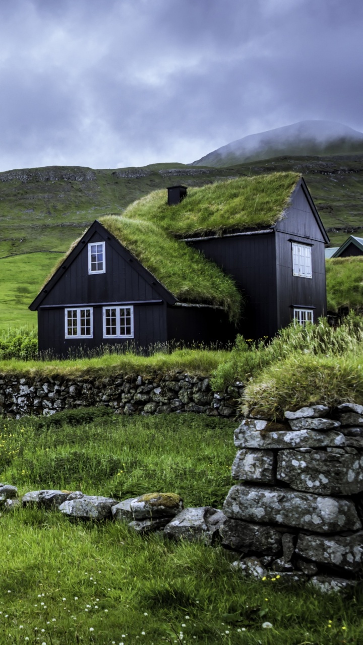 Brown Wooden House on Green Grass Field Near Mountain Under White Clouds During Daytime. Wallpaper in 720x1280 Resolution