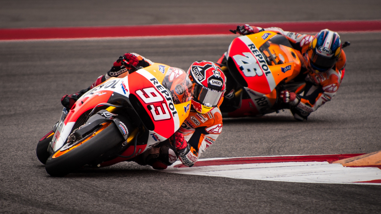 Man in Orange and Black Racing Suit Riding on Sports Bike. Wallpaper in 1280x720 Resolution