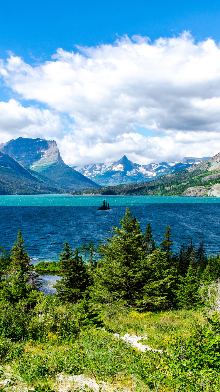 Green Trees Near Blue Lake Under Blue Sky During Daytime. Wallpaper in 750x1334 Resolution