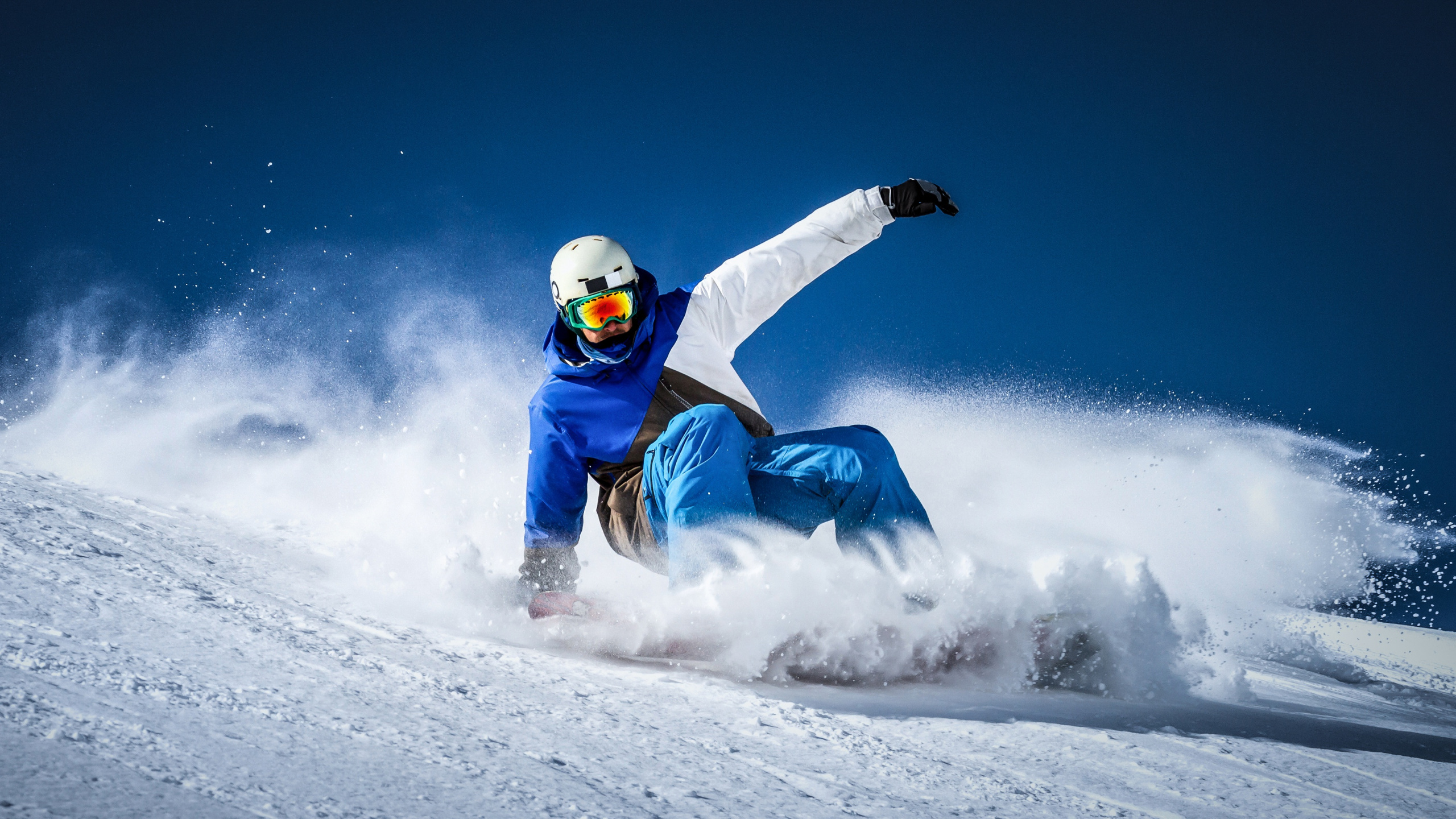 Person in Blue and White Snow Suit Riding on White Snow Mobile During Daytime. Wallpaper in 2560x1440 Resolution