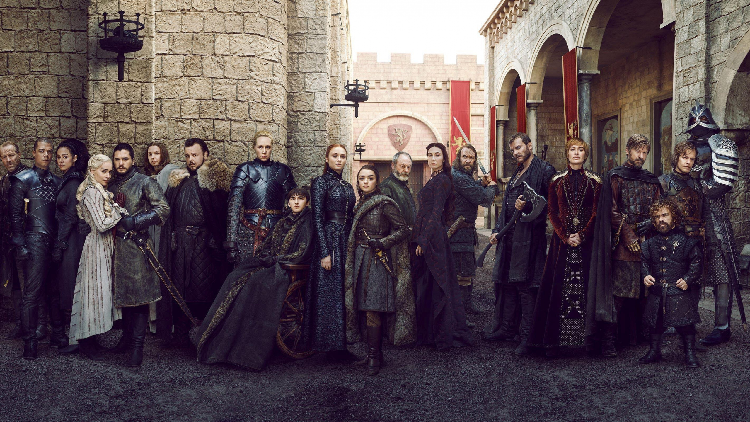 Group of People Standing Near Brown Brick Wall. Wallpaper in 2560x1440 Resolution