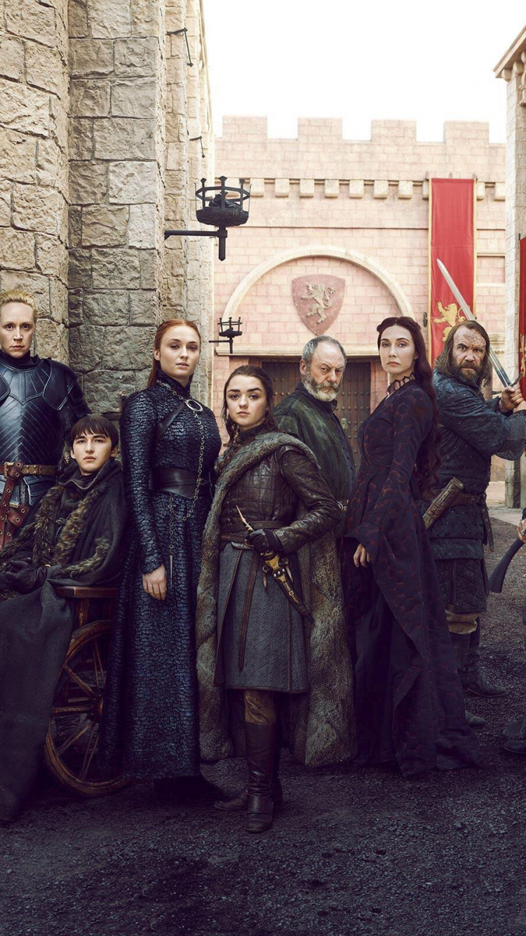 Group of People Standing Near Brown Brick Wall. Wallpaper in 750x1334 Resolution