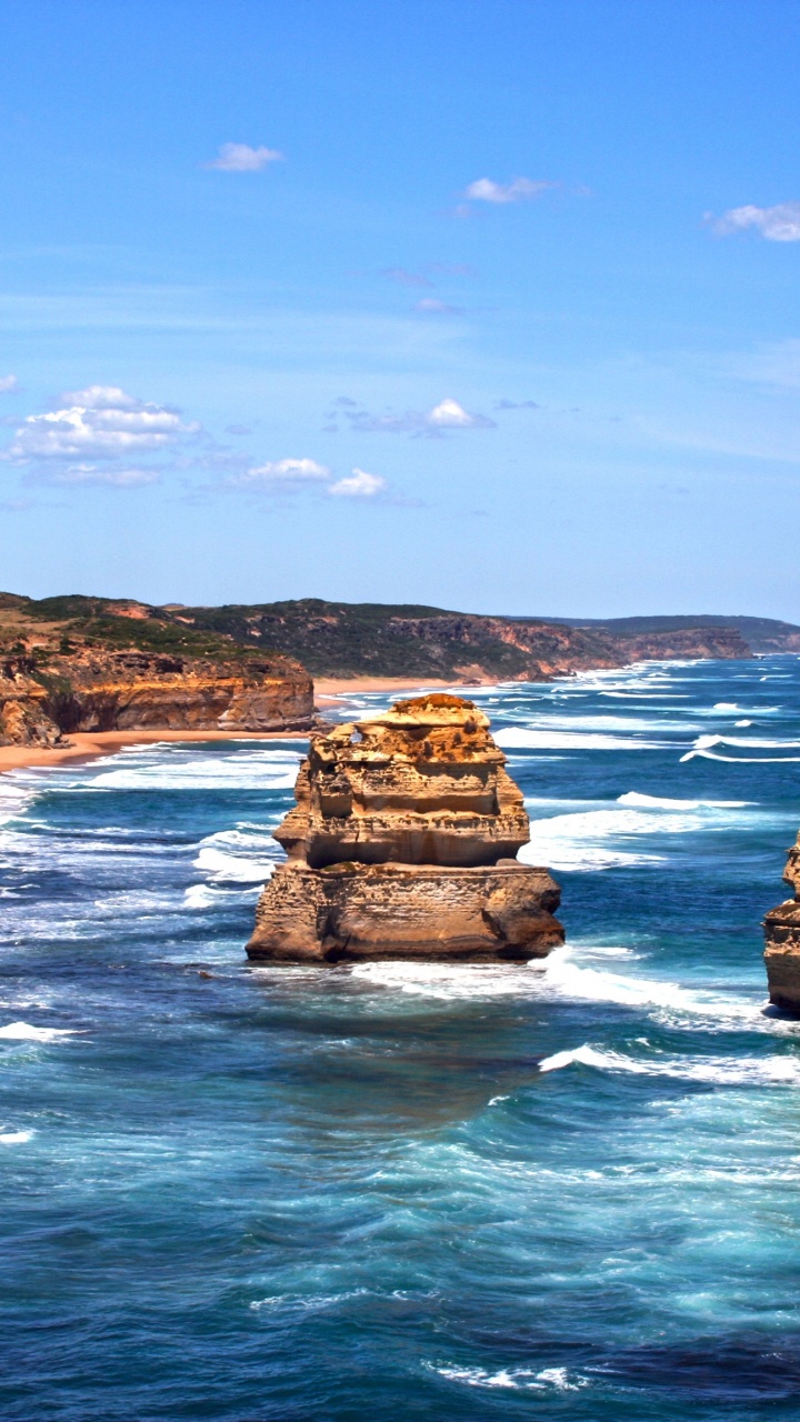 Brown Rock Formation on Sea Under Blue Sky During Daytime. Wallpaper in 720x1280 Resolution