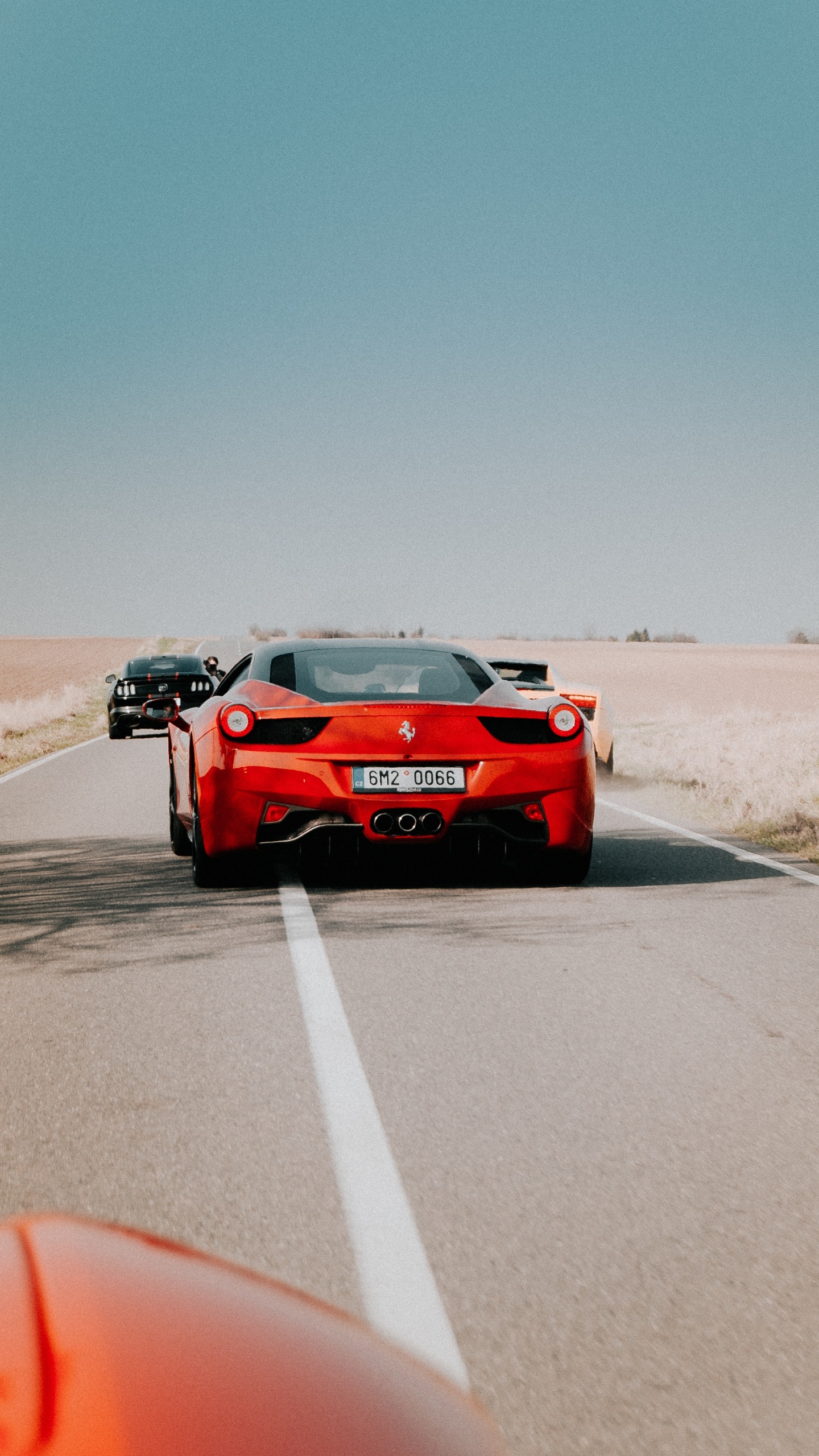 Red Porsche 911 on Gray Asphalt Road During Daytime. Wallpaper in 1440x2560 Resolution