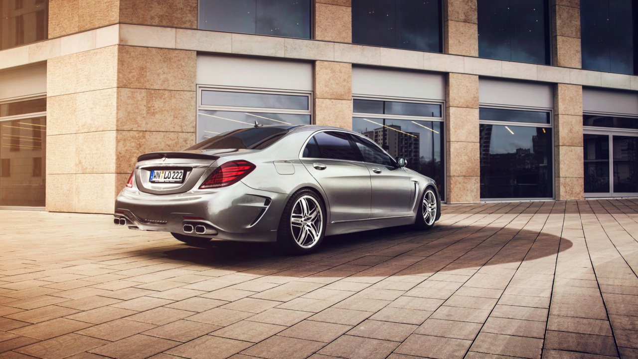 Silver Mercedes Benz Coupe Parked Beside Brown Brick Building. Wallpaper in 1280x720 Resolution