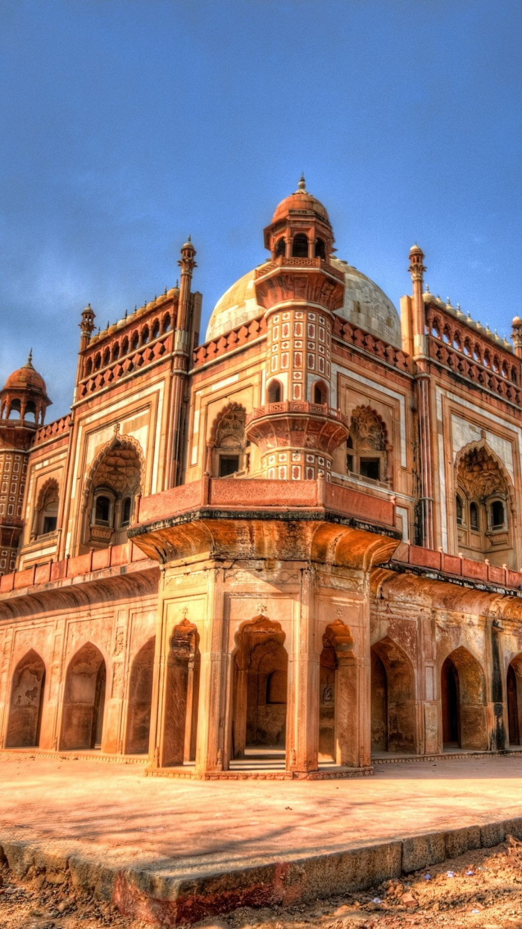 Brown Concrete Building Under Blue Sky During Daytime. Wallpaper in 750x1334 Resolution