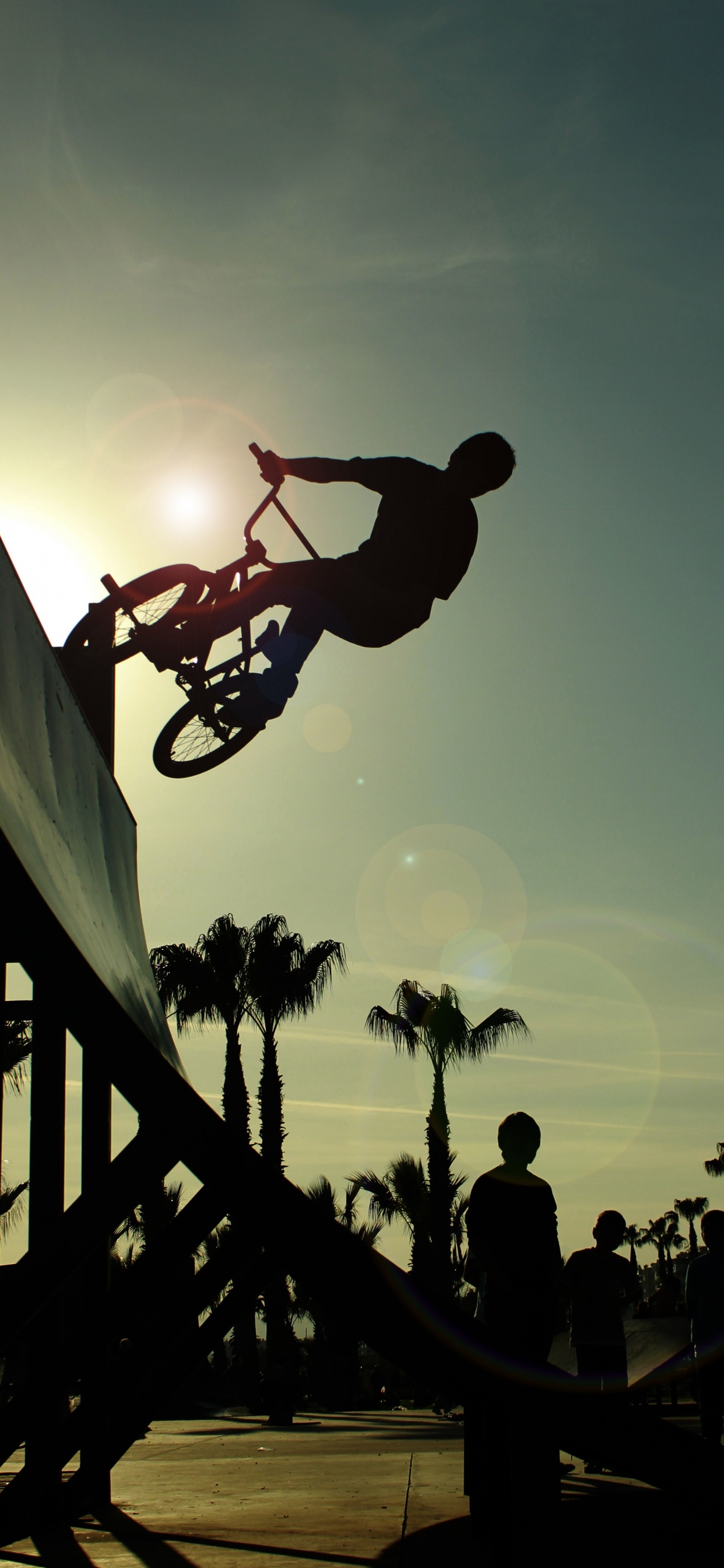 Silhouette of Man Playing Basketball During Sunset. Wallpaper in 1242x2688 Resolution