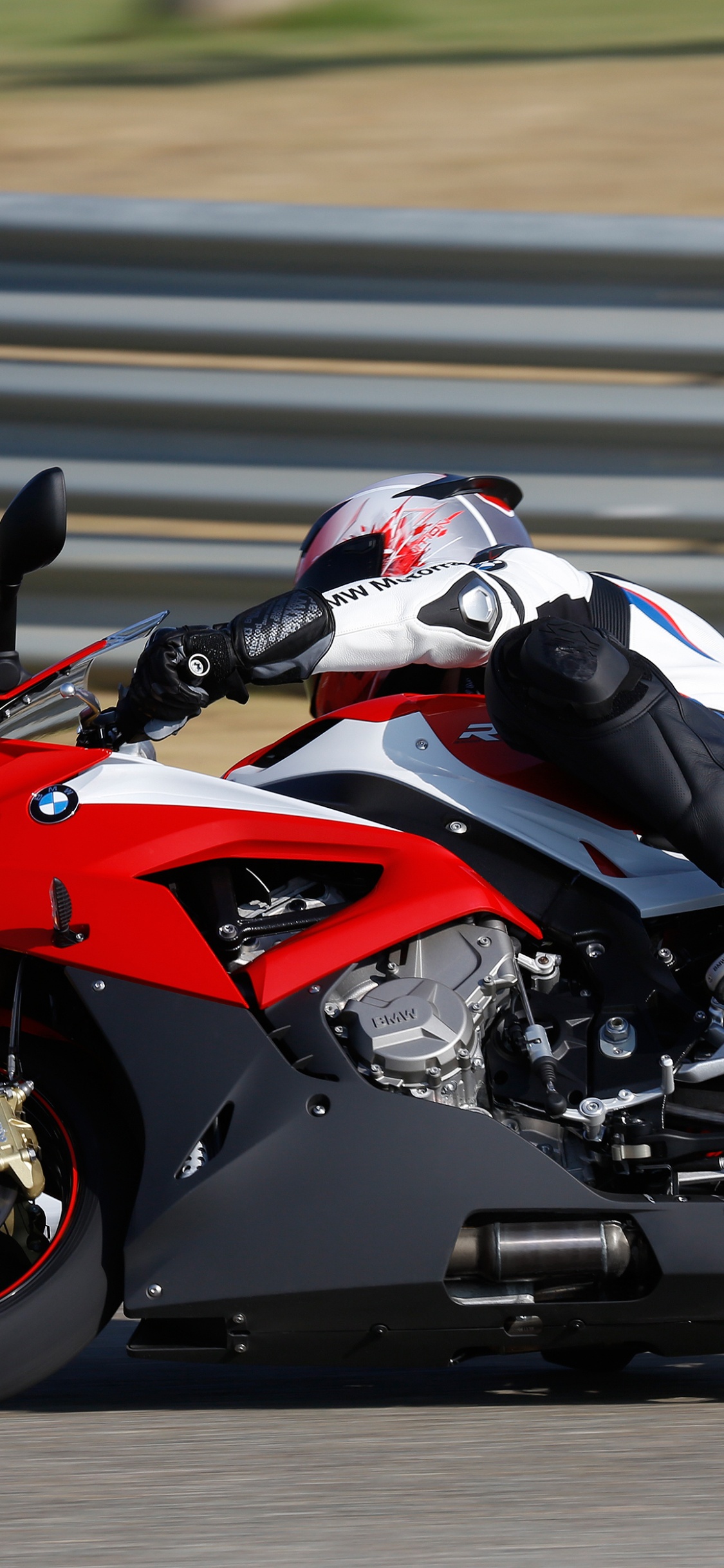 Man in Black and Red Sports Bike Helmet Riding on Red and Black Sports Bike. Wallpaper in 1125x2436 Resolution