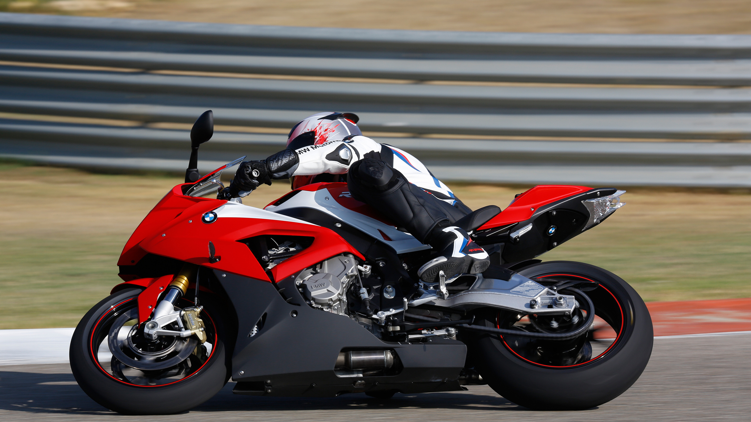 Man in Black and Red Sports Bike Helmet Riding on Red and Black Sports Bike. Wallpaper in 2560x1440 Resolution