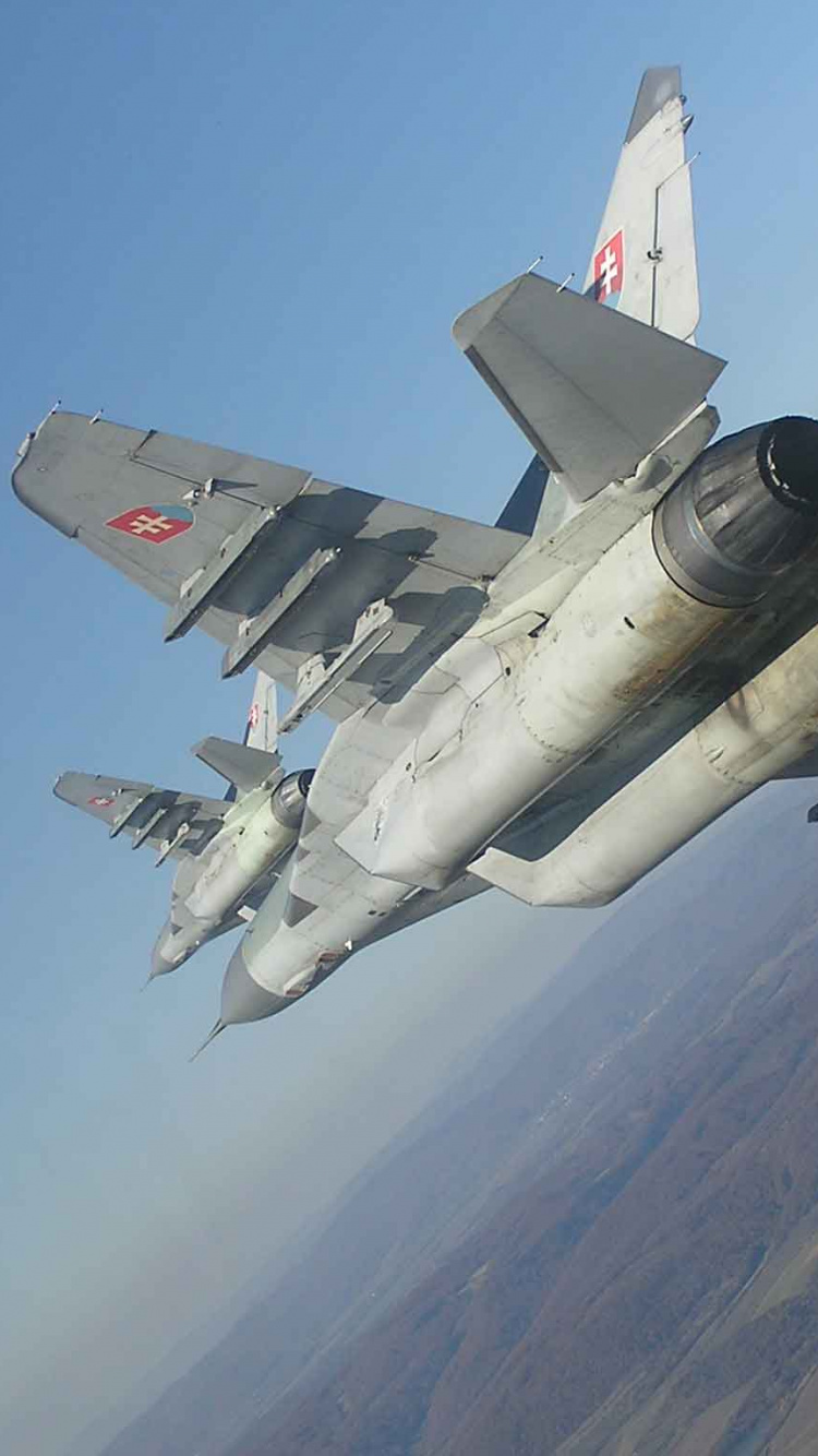 Gray Fighter Jet Flying Over The Mountain During Daytime. Wallpaper in 750x1334 Resolution
