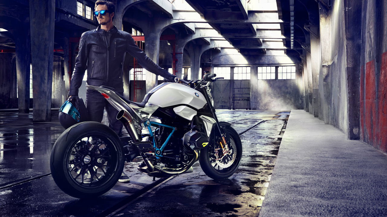 Man in Black Jacket Standing Beside Black Motorcycle. Wallpaper in 1280x720 Resolution