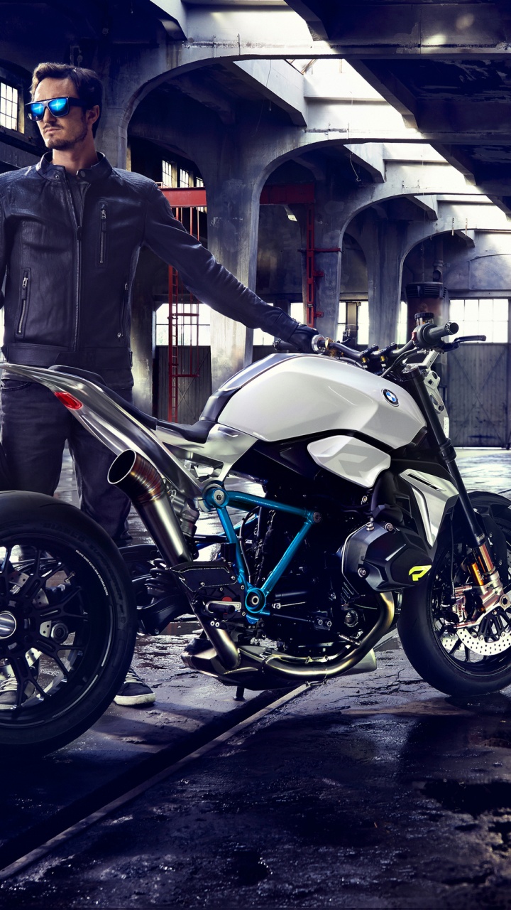 Man in Black Jacket Standing Beside Black Motorcycle. Wallpaper in 720x1280 Resolution