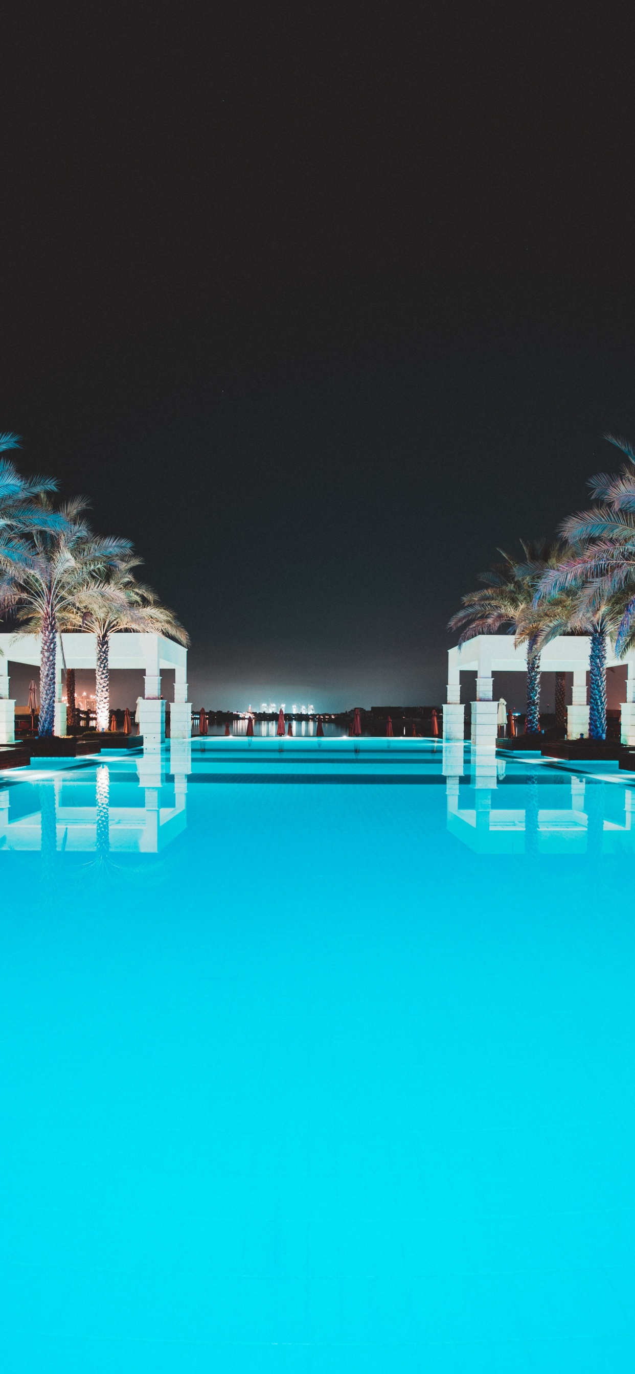 Swimming Pool With Trees in The Distance. Wallpaper in 1242x2688 Resolution