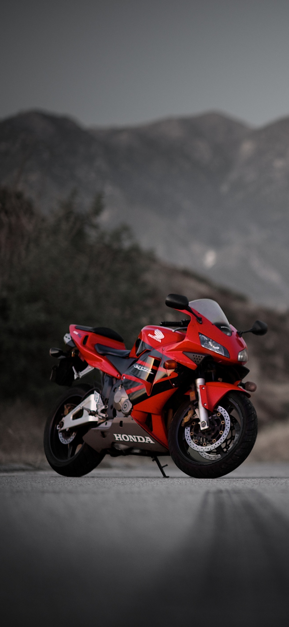 Red and Black Sports Bike on Road During Daytime. Wallpaper in 1125x2436 Resolution