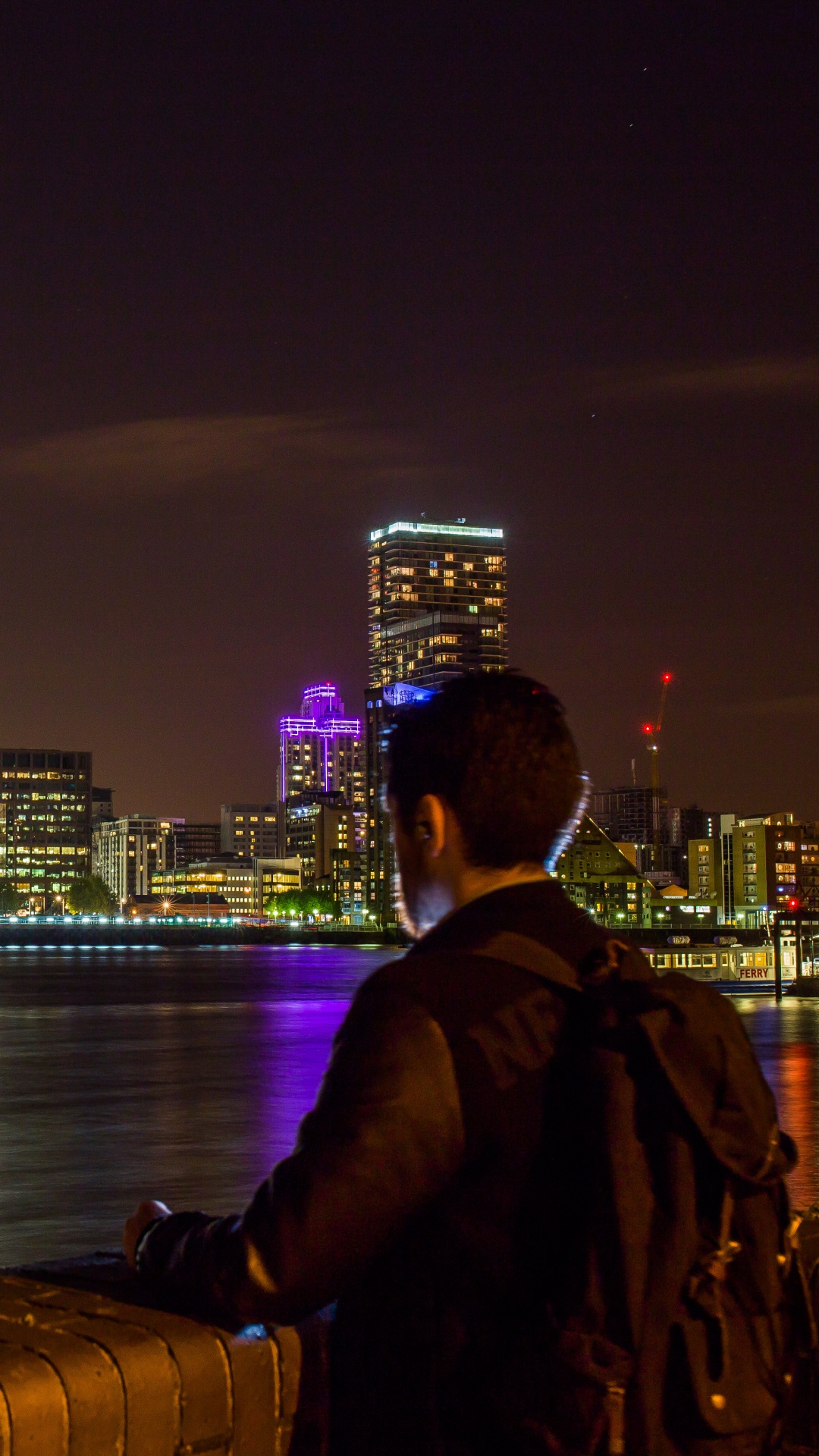 Man in Black Jacket Sitting on Brown Wooden Dock During Night Time. Wallpaper in 1080x1920 Resolution