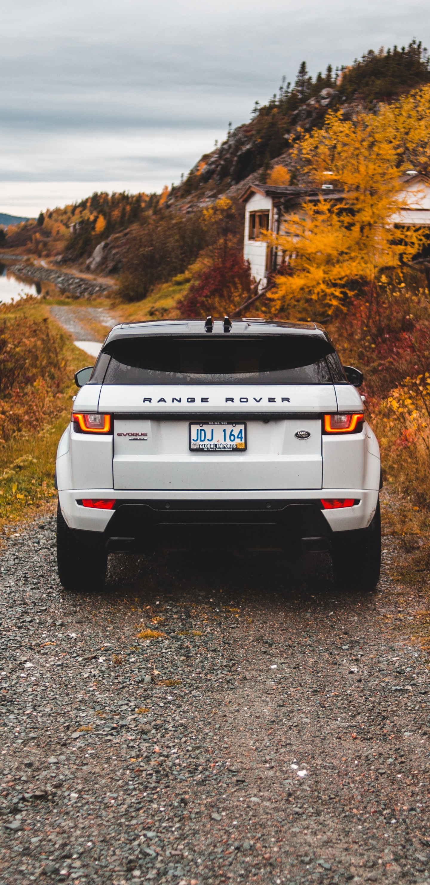 White Nissan Suv on Gray Dirt Road During Daytime. Wallpaper in 1440x2960 Resolution