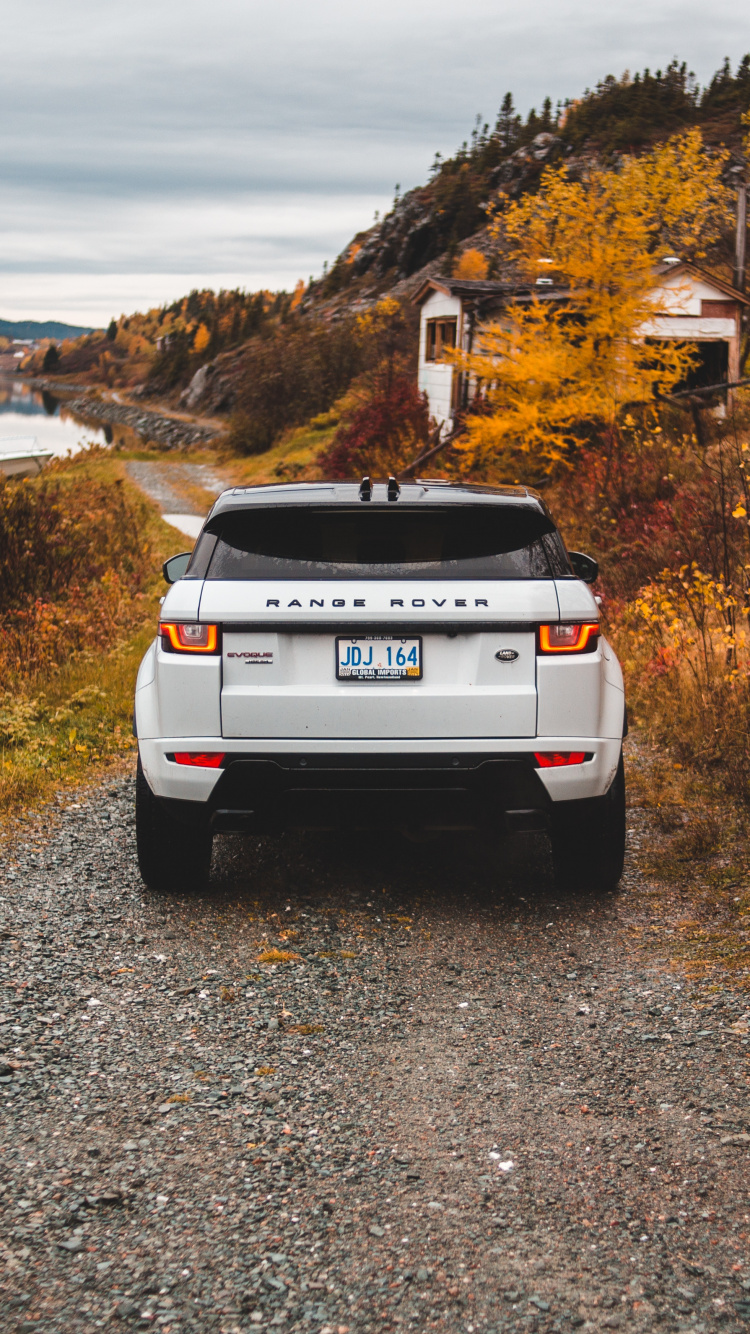 White Nissan Suv on Gray Dirt Road During Daytime. Wallpaper in 750x1334 Resolution