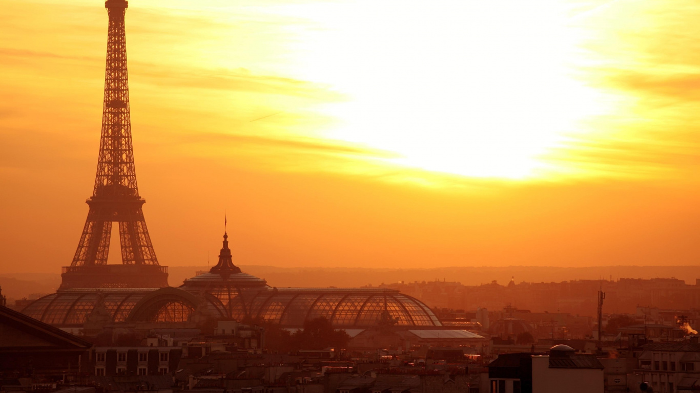 City Buildings During Sunset With Tower Clock. Wallpaper in 1366x768 Resolution