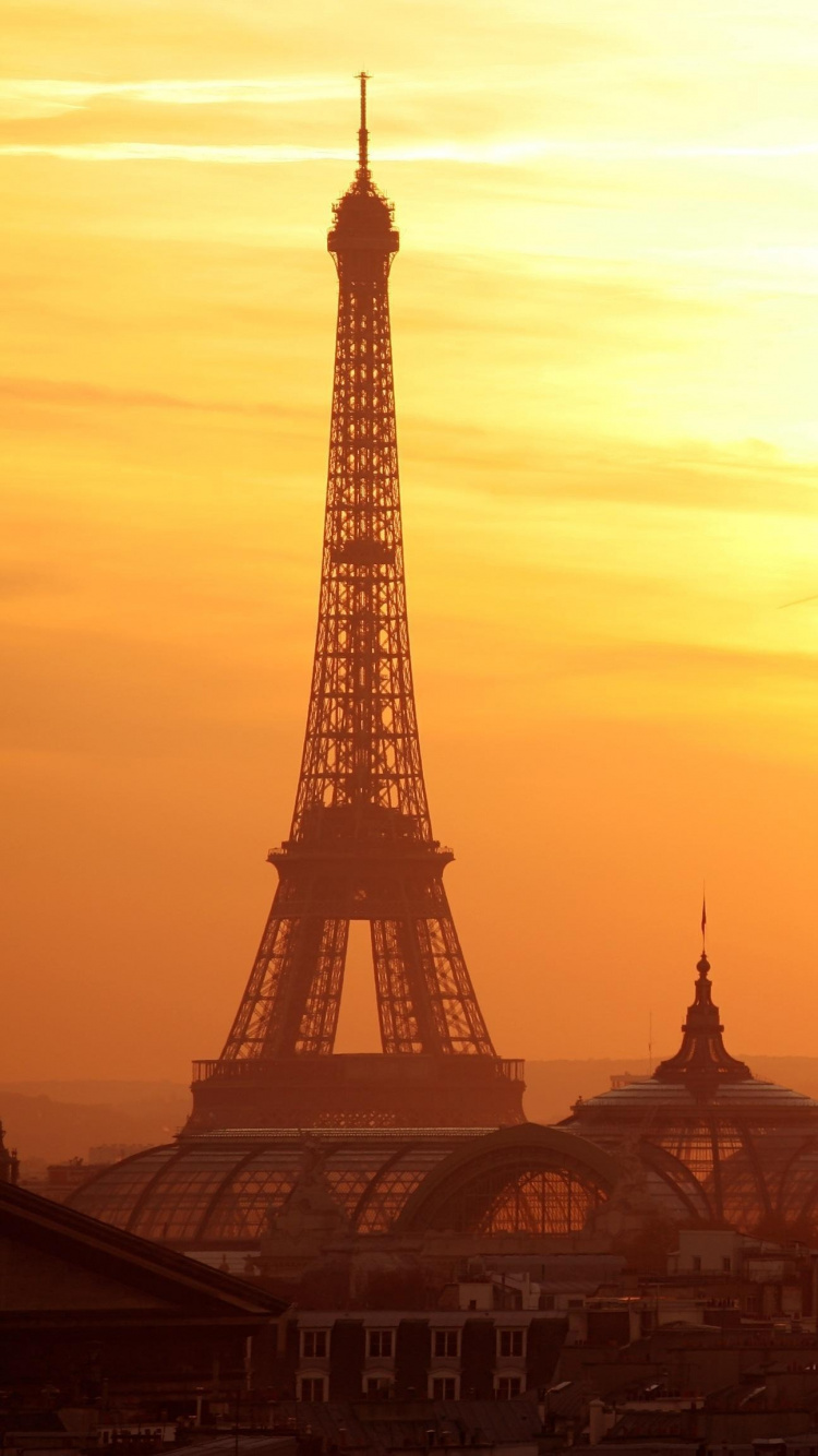 City Buildings During Sunset With Tower Clock. Wallpaper in 750x1334 Resolution