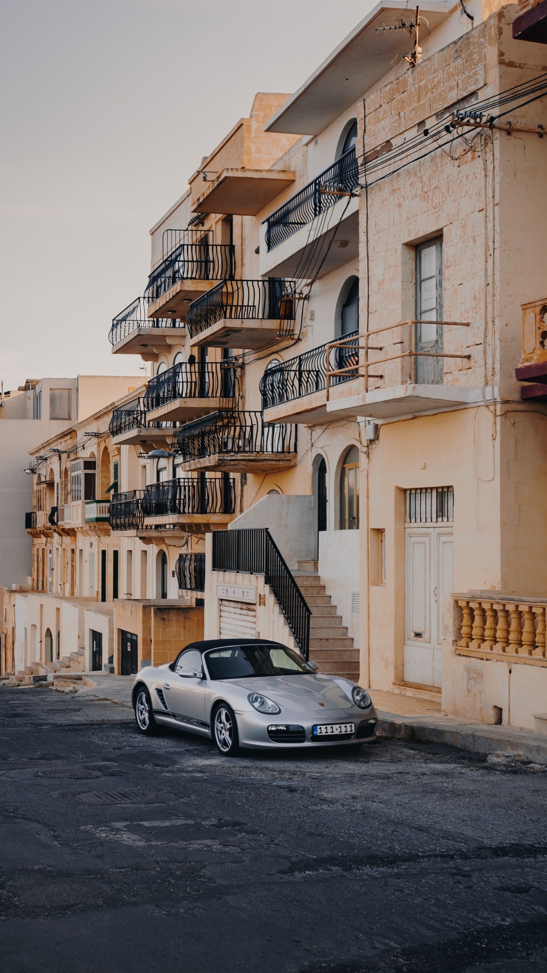 White Porsche 911 Parked Beside Yellow Concrete Building During Daytime. Wallpaper in 1080x1920 Resolution