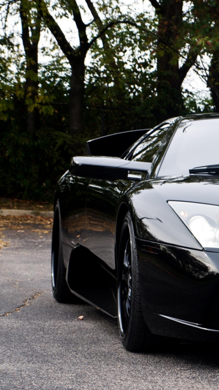 Black Porsche 911 Parked on Gray Concrete Pavement Near Green Trees During Daytime. Wallpaper in 750x1334 Resolution