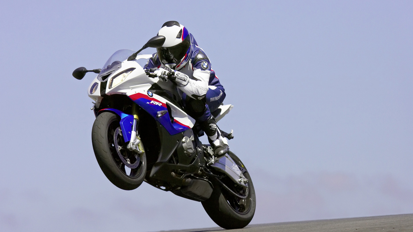 Man in White and Black Motorcycle Helmet Riding White and Black Sports Bike. Wallpaper in 1366x768 Resolution