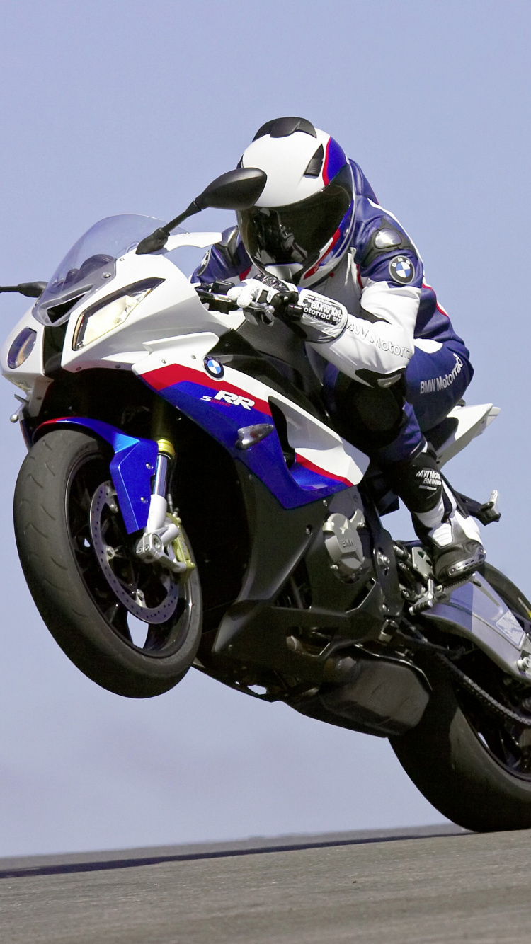 Man in White and Black Motorcycle Helmet Riding White and Black Sports Bike. Wallpaper in 750x1334 Resolution