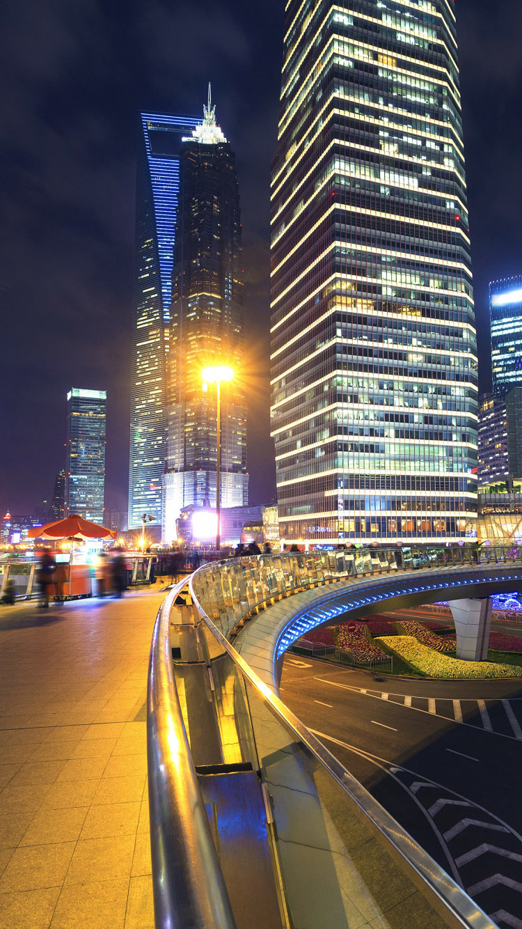 Cars on Road Near High Rise Buildings During Night Time. Wallpaper in 750x1334 Resolution