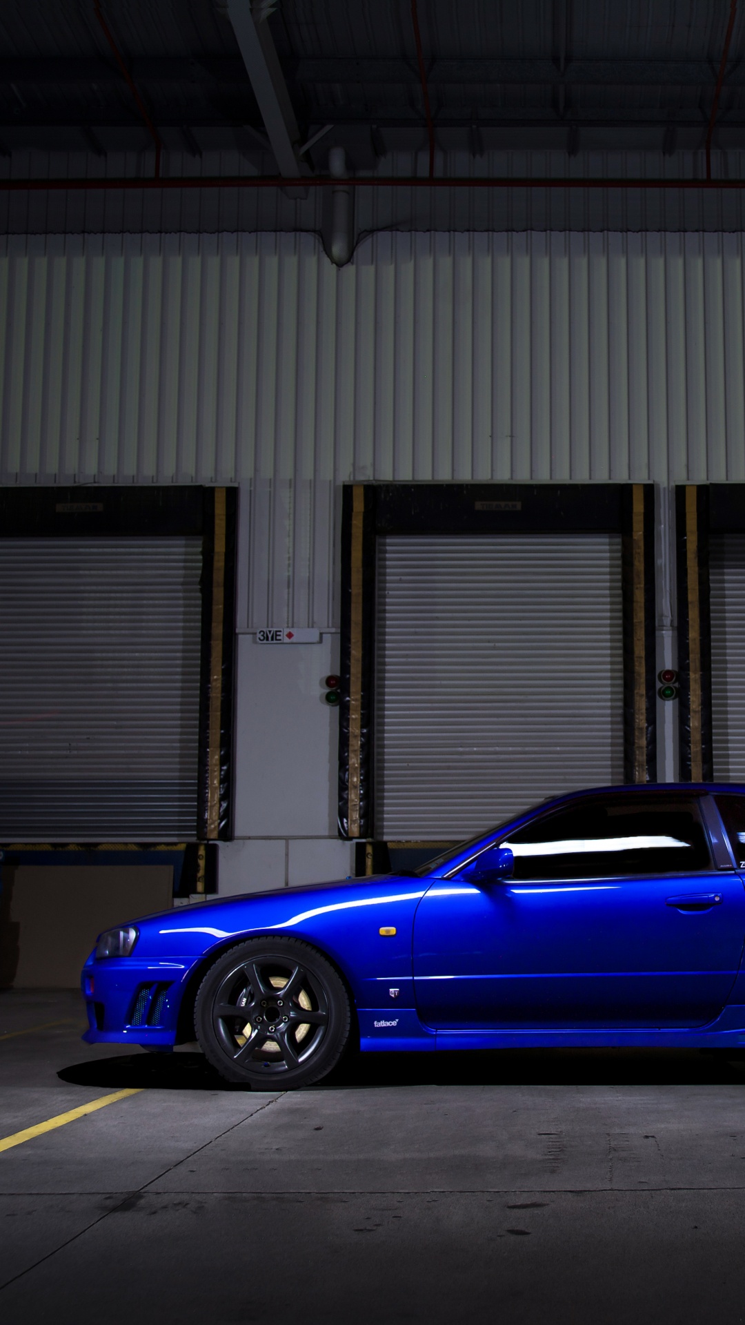 Blue Sedan Parked in Front of Building. Wallpaper in 1080x1920 Resolution