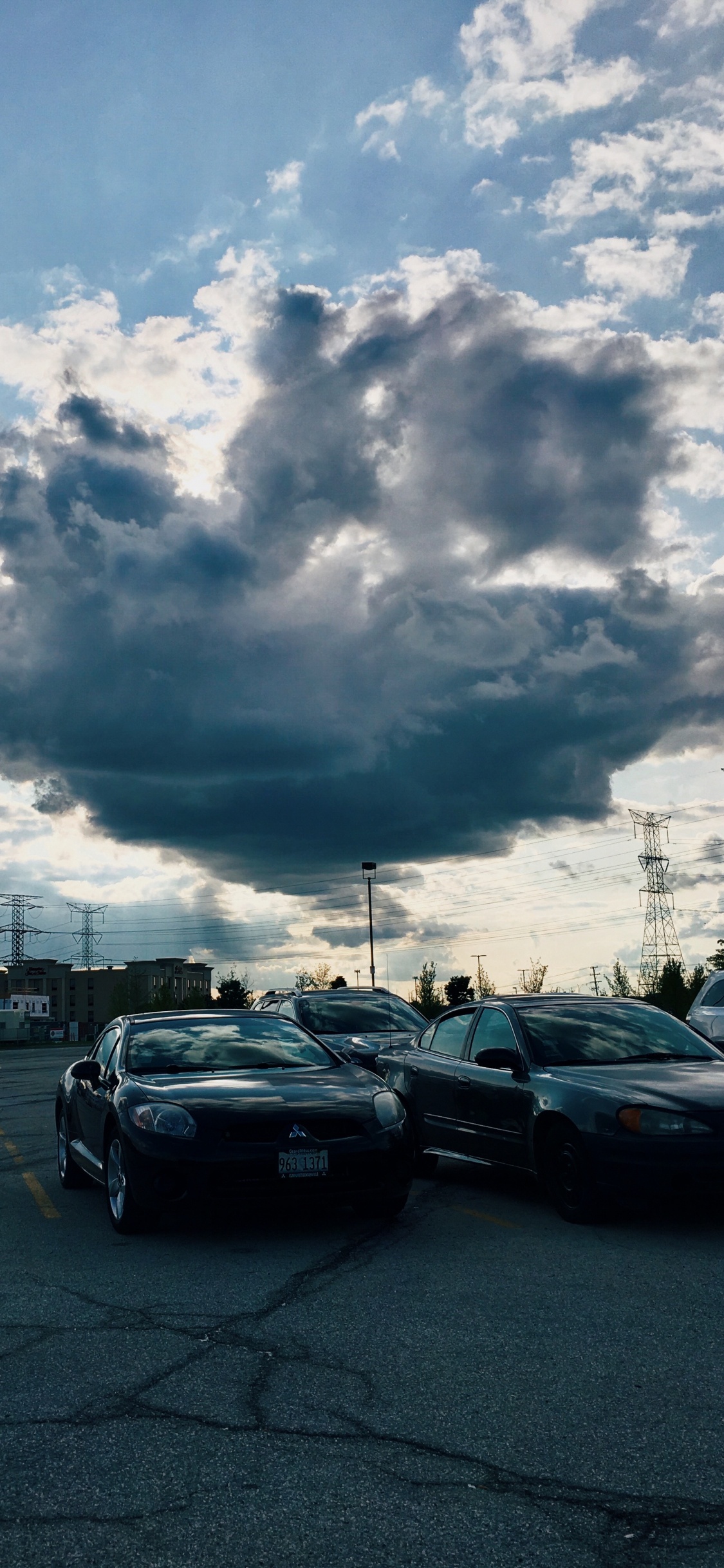 Cars on Road Under Cloudy Sky During Daytime. Wallpaper in 1125x2436 Resolution
