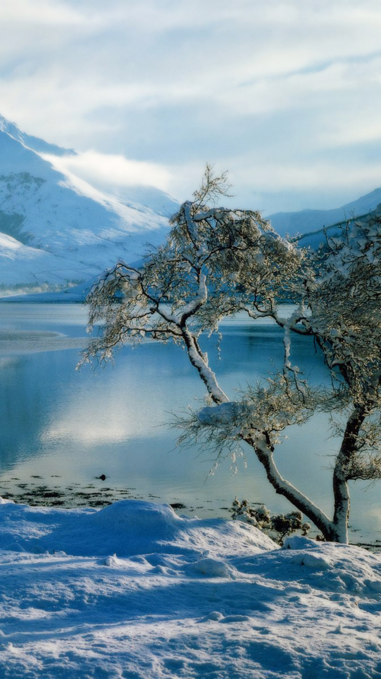 Snow Covered Mountain Near Lake During Daytime. Wallpaper in 750x1334 Resolution