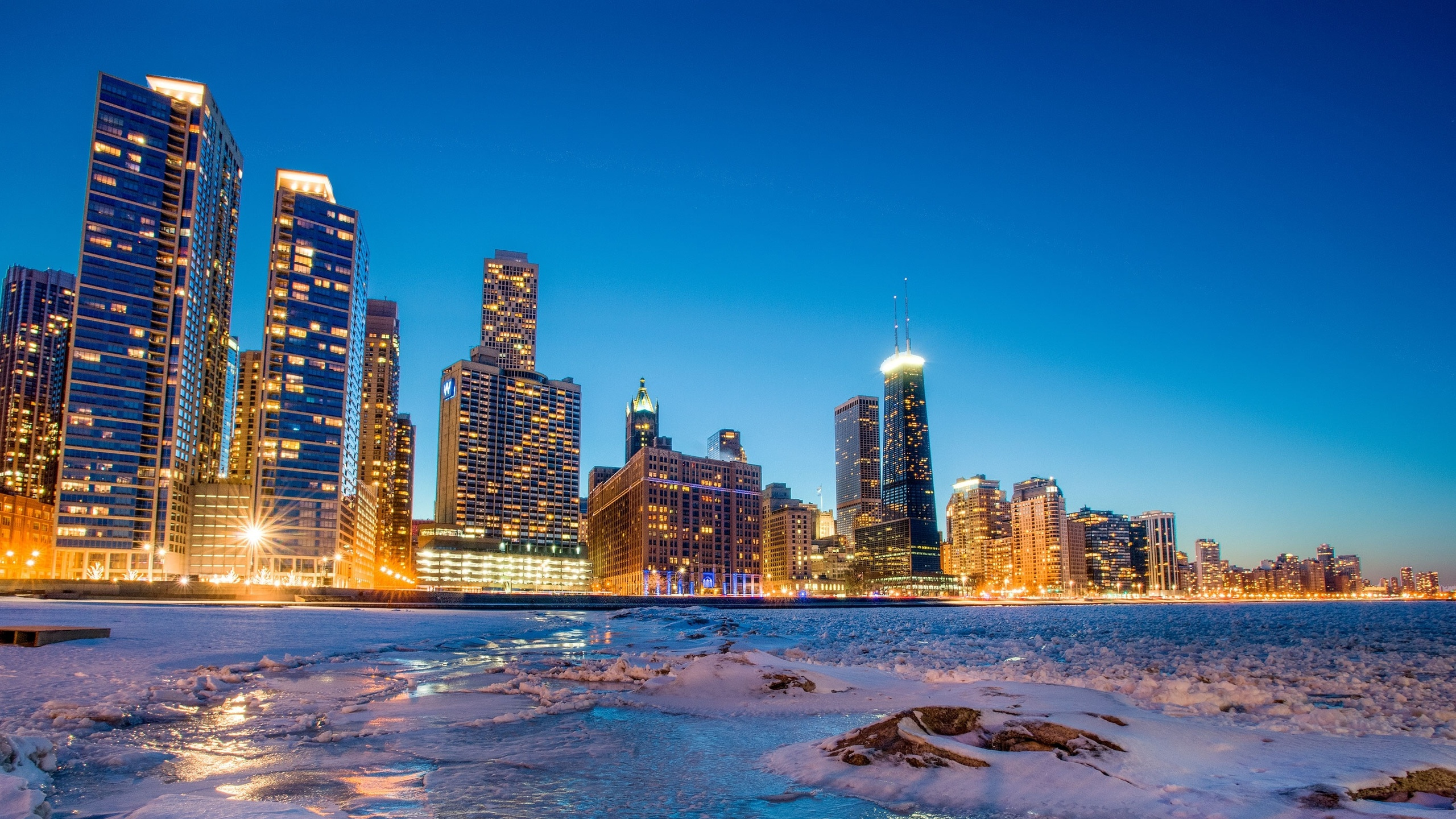 City Skyline Across Body of Water During Night Time. Wallpaper in 2560x1440 Resolution
