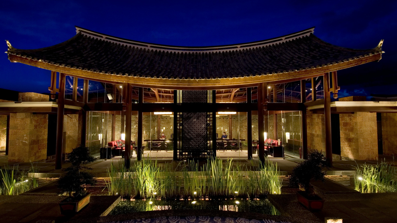 Brown Wooden Building With Lights Turned on During Night Time. Wallpaper in 1366x768 Resolution