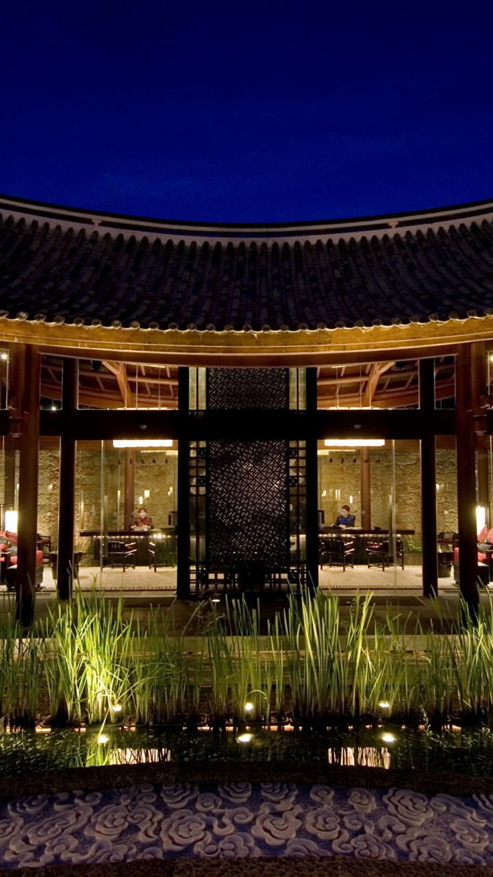 Brown Wooden Building With Lights Turned on During Night Time. Wallpaper in 720x1280 Resolution