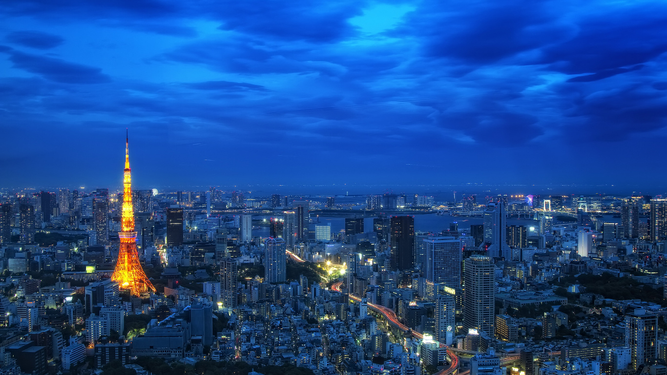 Skyline Der Stadt Unter Blauem Himmel Während Der Nacht. Wallpaper in 1366x768 Resolution