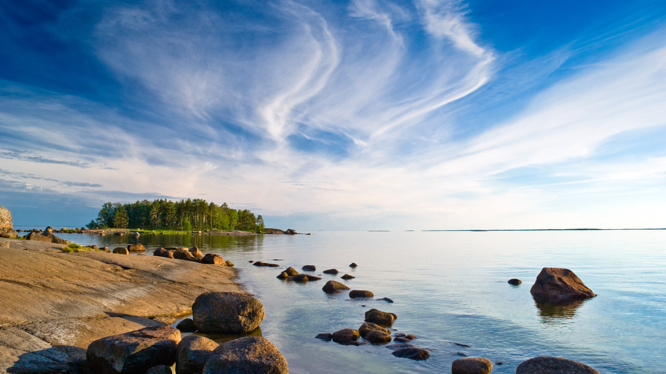 Brown Rocks on Body of Water Under Blue Sky During Daytime. Wallpaper in 1366x768 Resolution