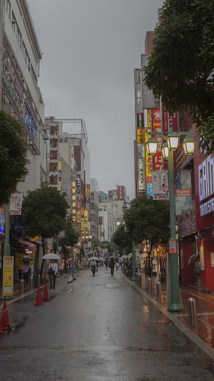 People Walking on Street Between Buildings During Daytime. Wallpaper in 720x1280 Resolution