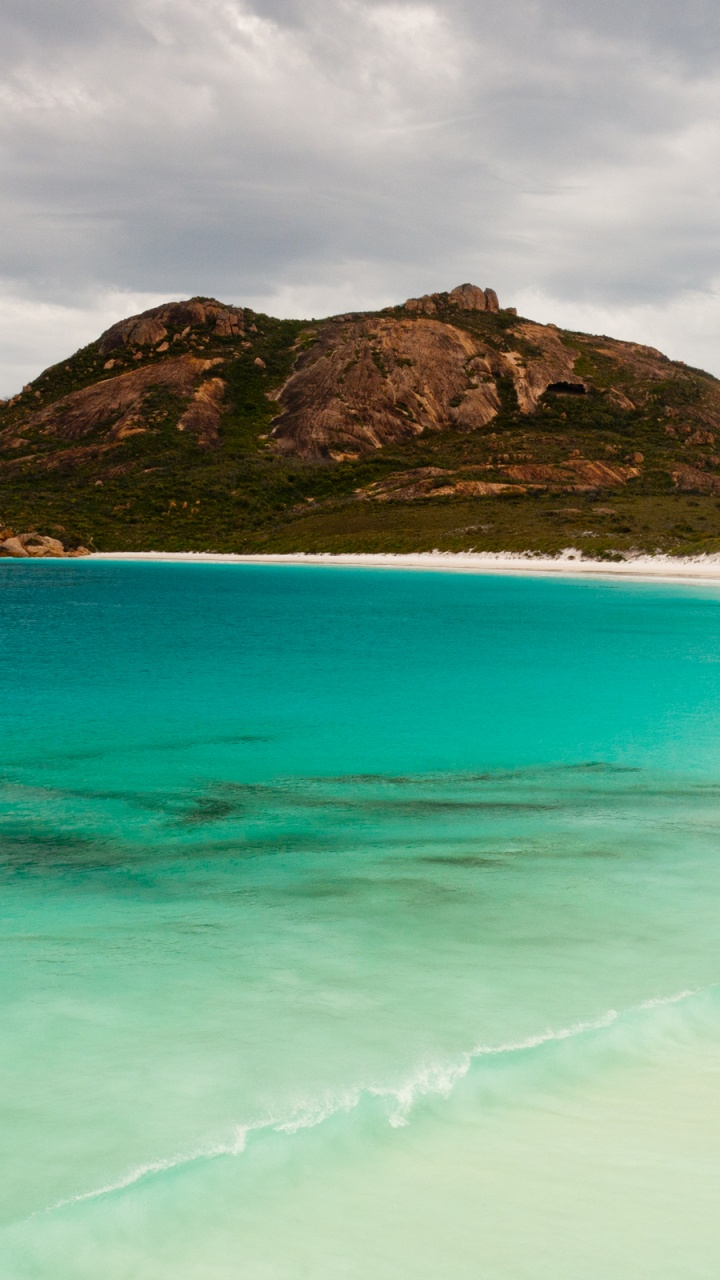 Green and Brown Mountain Beside Body of Water During Daytime. Wallpaper in 720x1280 Resolution