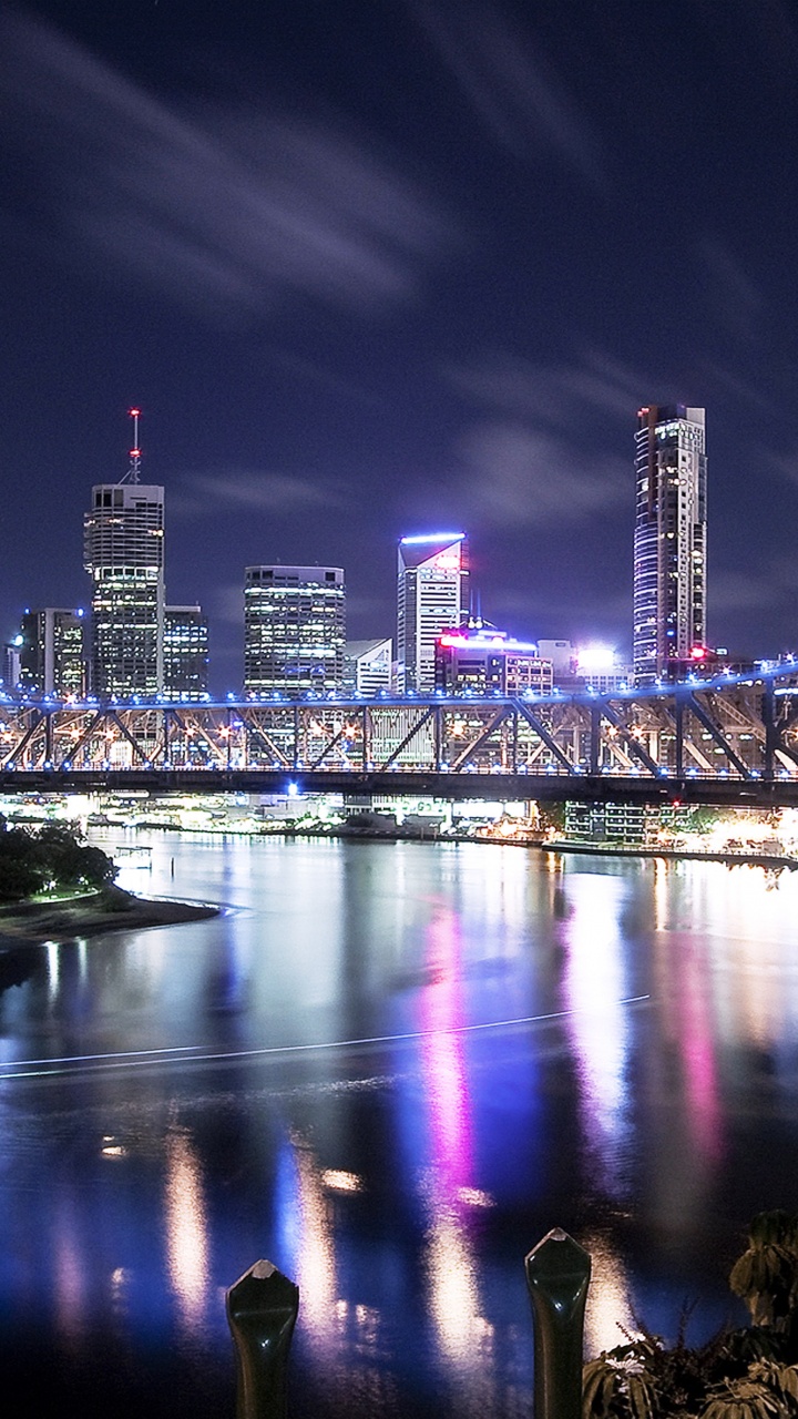 People Sitting on Bench Near Bridge During Night Time. Wallpaper in 720x1280 Resolution