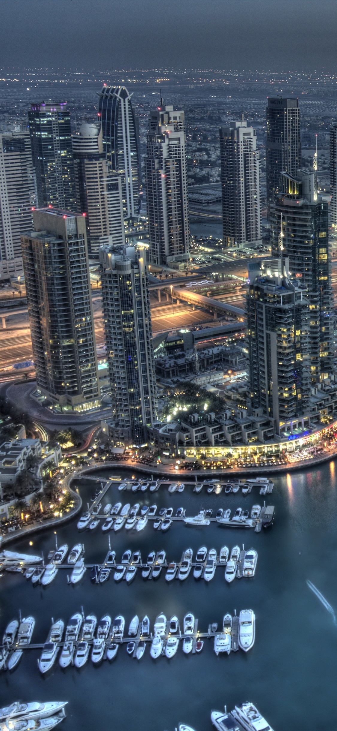 Aerial View of City Buildings During Night Time. Wallpaper in 1125x2436 Resolution
