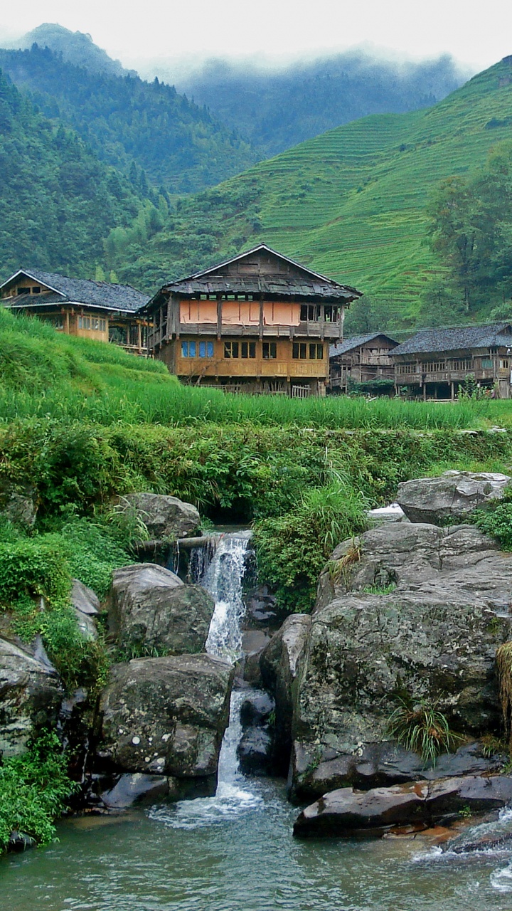 Brown Wooden House Near Water Falls During Daytime. Wallpaper in 720x1280 Resolution