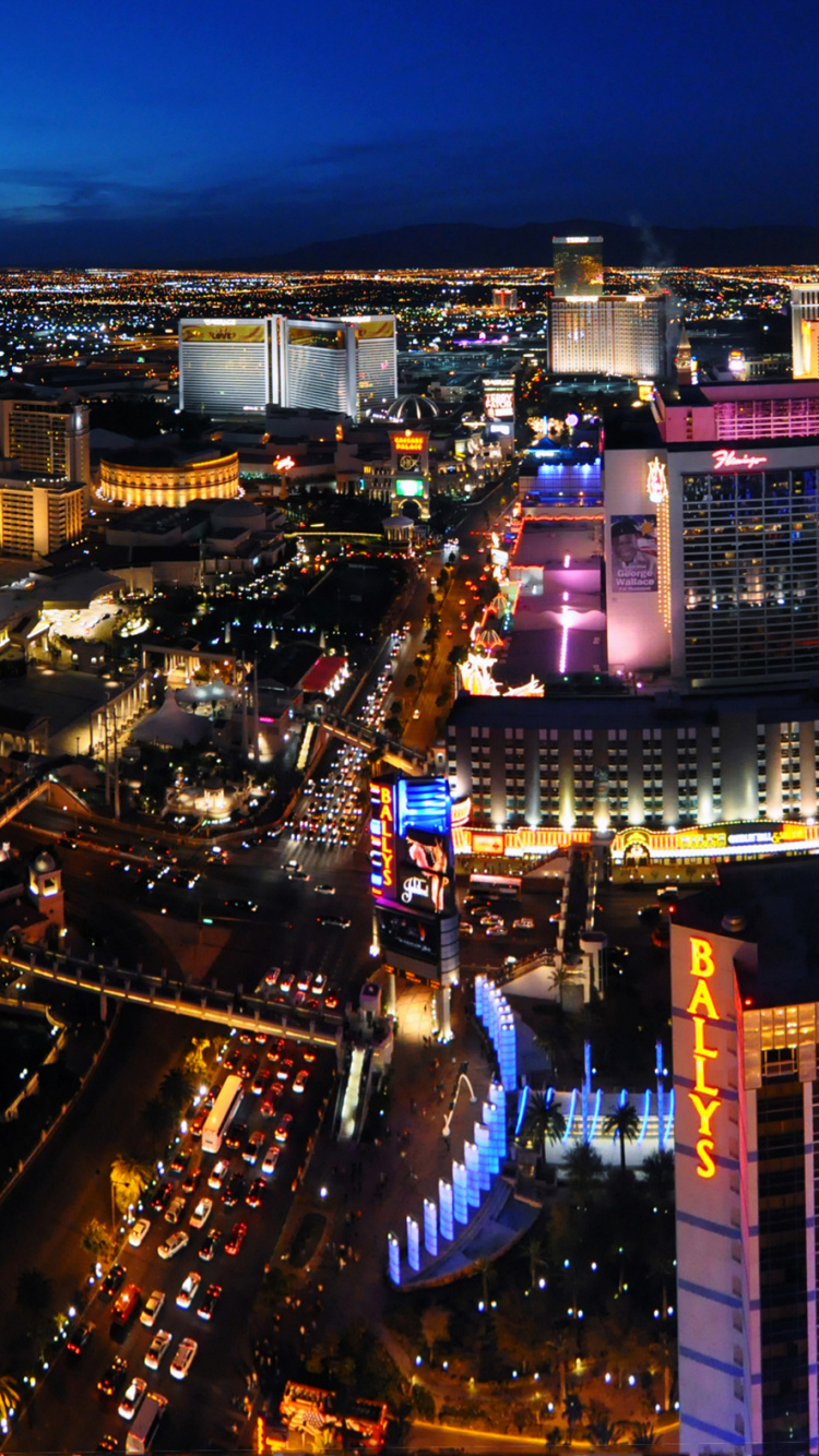 Vista Aérea de Los Edificios de la Ciudad Durante la Noche.. Wallpaper in 750x1334 Resolution