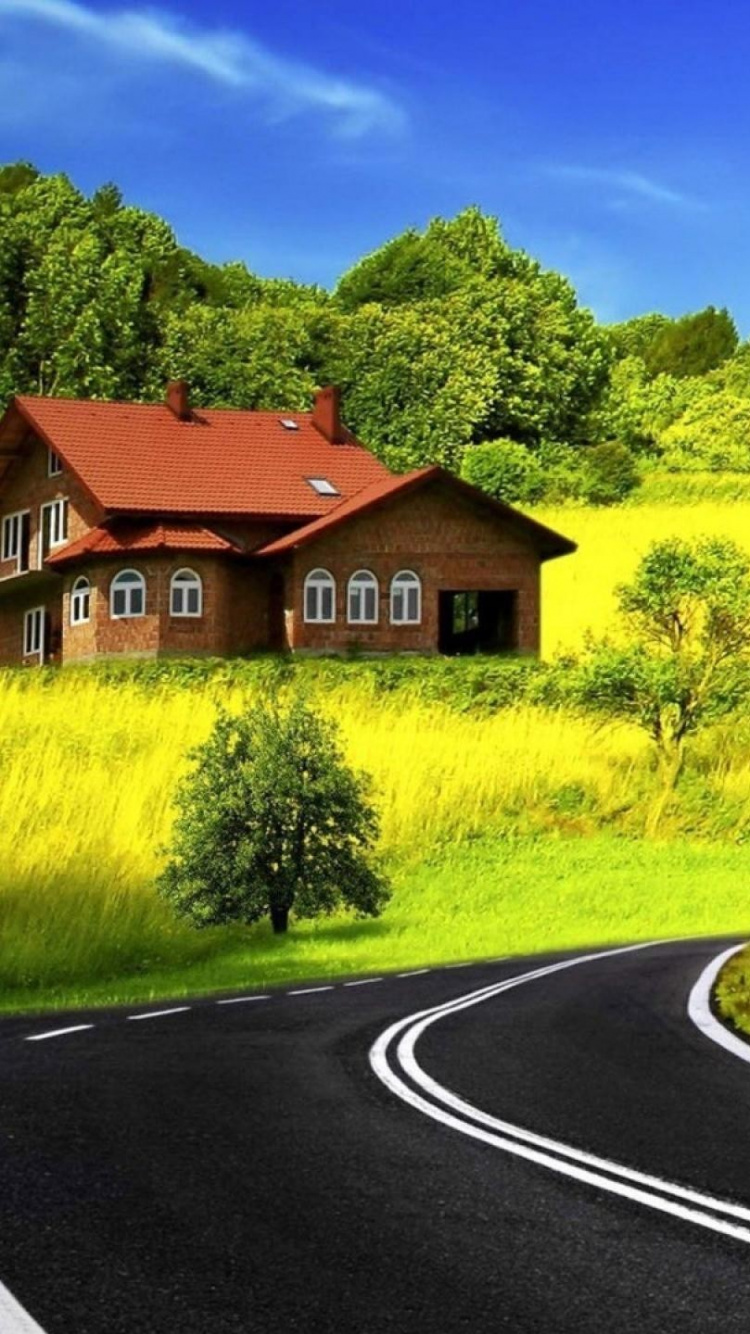 Black Asphalt Road Between Green Grass Field Under Blue Sky During Daytime. Wallpaper in 750x1334 Resolution