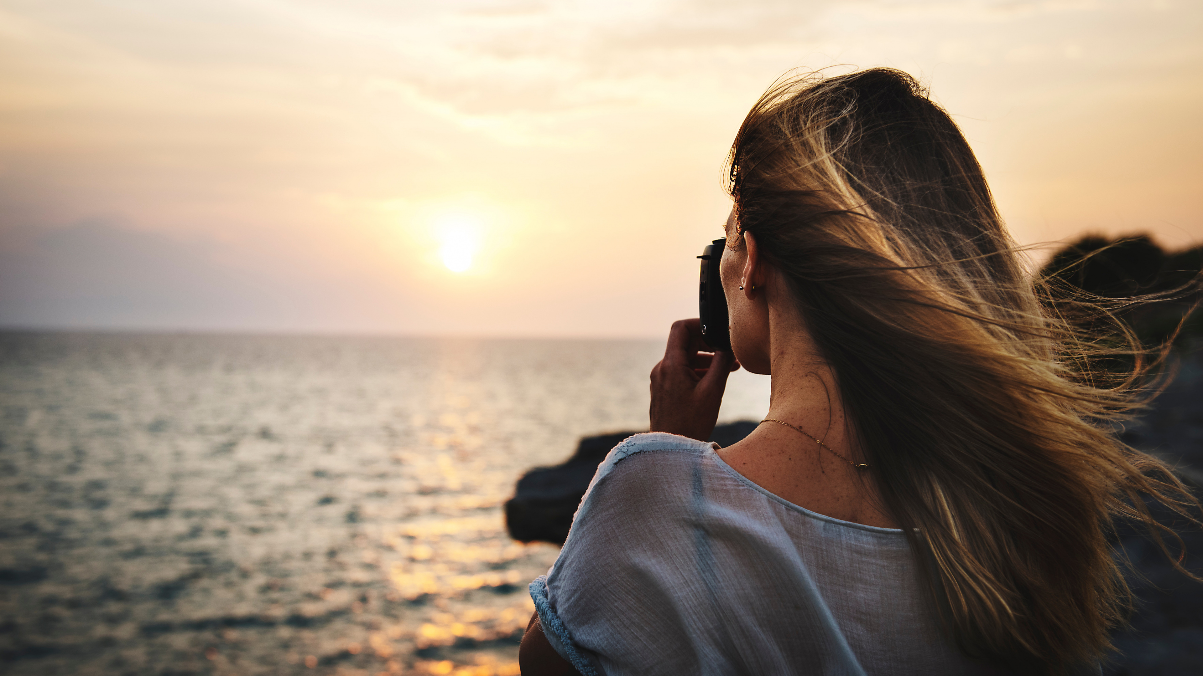 Woman in White Shirt Taking Photo of Sea During Daytime. Wallpaper in 3840x2160 Resolution
