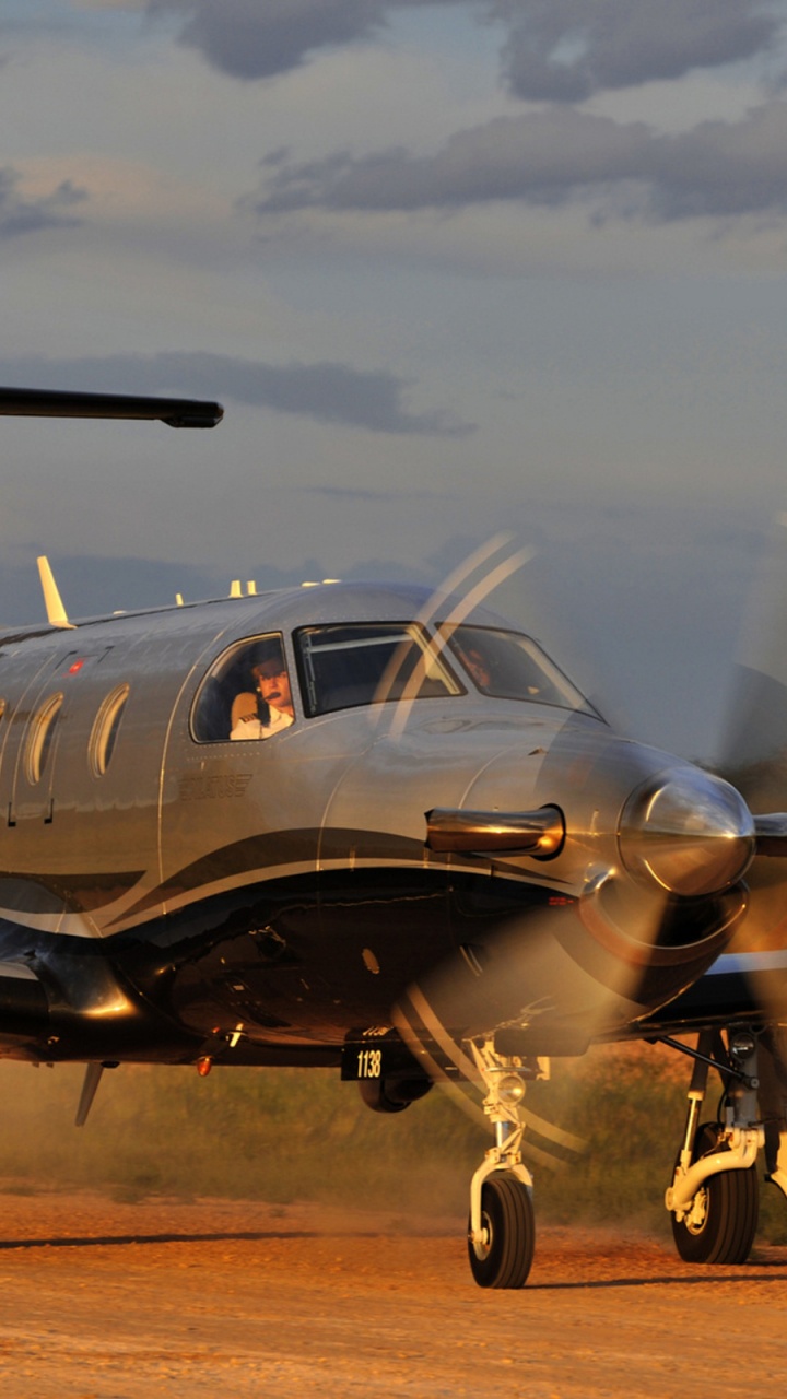 Gray and Blue Airplane on Brown Field Under White Clouds During Daytime. Wallpaper in 720x1280 Resolution