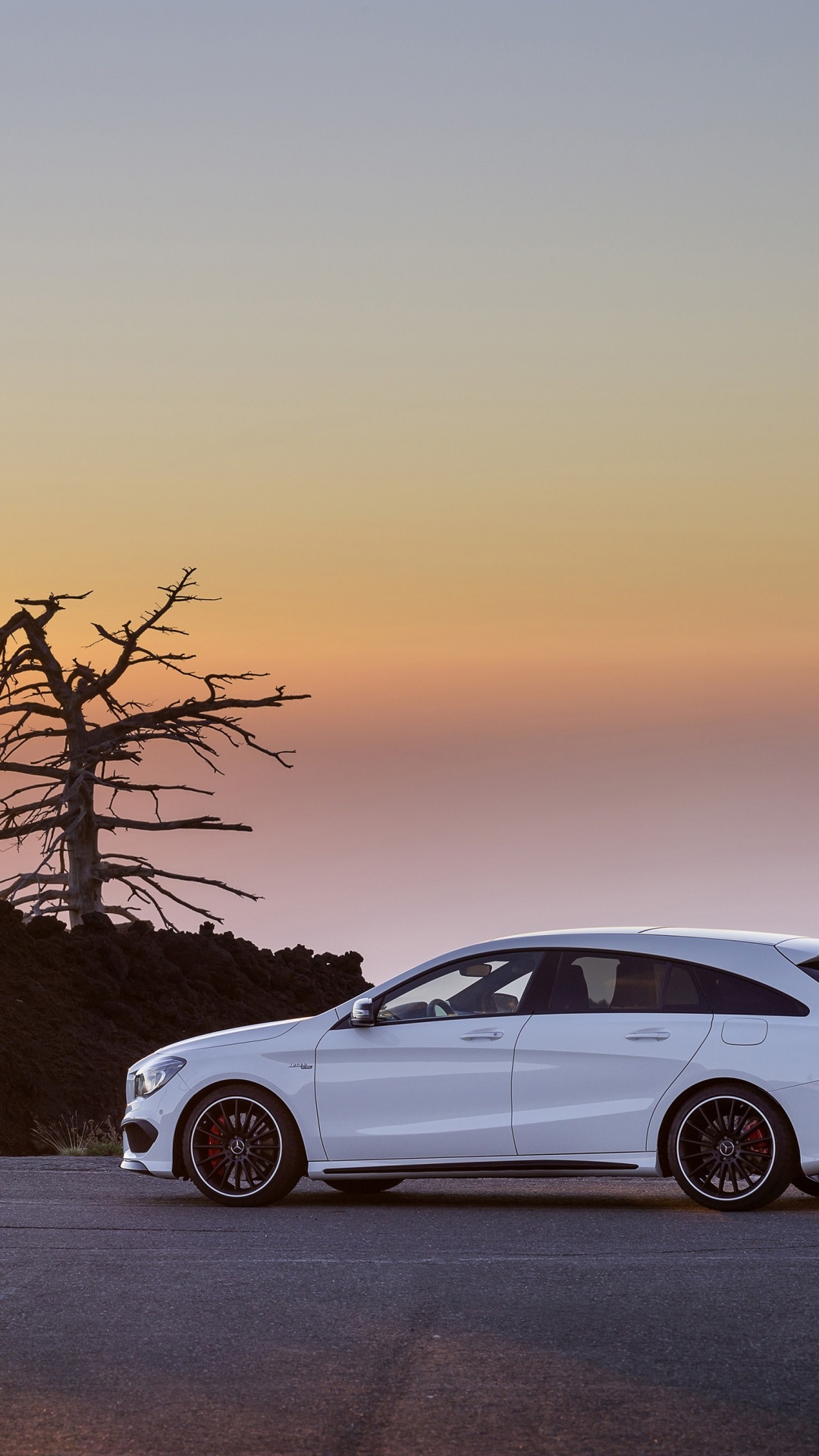 White Sedan on Snow Covered Road During Sunset. Wallpaper in 1080x1920 Resolution