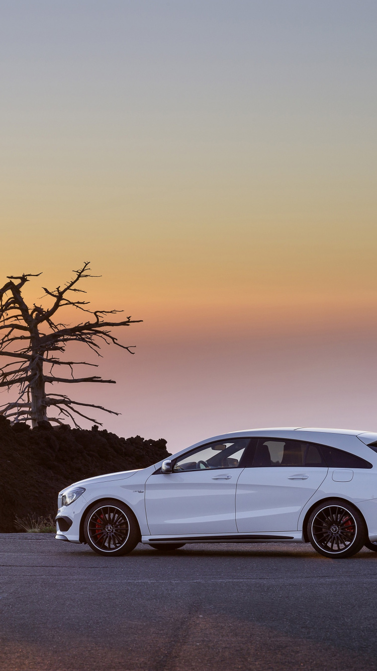 White Sedan on Snow Covered Road During Sunset. Wallpaper in 750x1334 Resolution