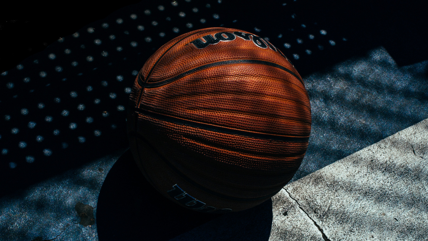 Brown Basketball on Black and White Textile. Wallpaper in 1366x768 Resolution